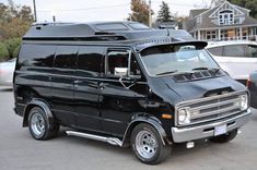 a black van is parked in a parking lot