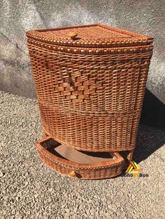 a brown wicker basket sitting on the ground