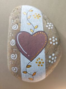 a painted rock with a heart on it