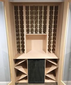 a wine cellar built into the side of a wall in a room with carpeted flooring