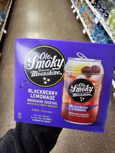 a person holding up a sign in a grocery store with the caption ole smoky moonshake