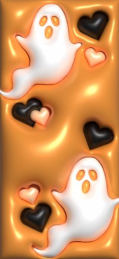 two white ghost faces with black hearts in the middle and one orange heart on top