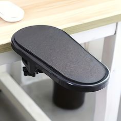 a computer desk with a keyboard and mouse on it, next to a black chair