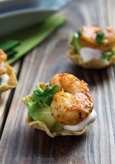 shrimp and avocado taco bites on a wooden table