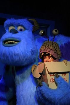 the blue monster is holding a cardboard box in front of him and his friend, sul from monsters