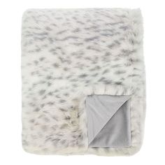 a blanket with grey and white spots on it