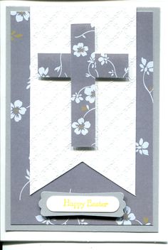 a greeting card with a cross and flowers on the front in white, gray and yellow