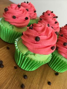 some cupcakes with pink frosting and chocolate chips