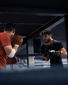 two men are practicing boxing in the ring