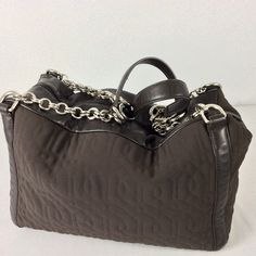 "Simply amazing > Vintage Donald J. Pliner Designer Nylon Leather Chain Shoulder Bag Brown nylon and leather Fully nice chrome zipper along the top, beautiful chain handles . Opens to a clean logo green fabric, interior with a small zipper pocket and logo. Guaranteed 100% Authentic Size 15\"L x 7\"W x 10\"H No defects. No damages Condition Report Excellent! preowned excellent overall Looks new like This item may have been worn but has no visible signs of wear No damages, stains, immaculate Pleas Clean Logo, Cleaning Logo, Travel Tote Bag, Travel Tote, Chain Shoulder Bag, Leather Chain, Green Fabric, Louis Vuitton Damier, Purses And Handbags