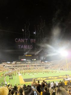 fireworks light up the night sky at a football game