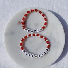 Show your school pride and complete your game day outfit with a custom crimson and white beaded bracelet for the University of Alabama! Adjustable Beaded Bracelets For Game Day With School Spirit, School Spirit Letter Beads Bracelets Gift, White Team Spirit Bracelets For Game Day, School Spirit Beaded Bracelets With Letter Beads For Gifts, School Spirit Beaded Bracelet With Letter Beads As Gift, Personalized Red Name Bracelet With Round Beads, Red Personalized Bracelets For Team Spirit, Red Personalized Bracelets With Team Spirit Style, Personalized Red Bracelets For Team Spirit