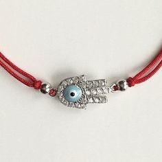 925 sterling silver hamsa evil eye red bracelet .adjustable .for protection ,good luck and prosperty. --comes with free gift pouche. pulsera rojo de plata esterlina 925 mano de fatima ojo de la buena suerte. ajustable. para proteccion ,buena suerte y prosperidad. --gratis bolsa de regalo. Hamsa Evil Eye, Red Bracelet, Red Bracelets, Pandora Charm Bracelet, Evil Eye, Free Gift, Good Luck, Turquoise Bracelet, Free Gifts