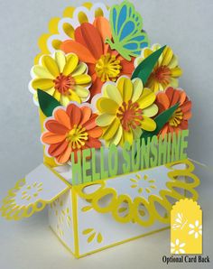 an open card box with flowers inside and the words hello sunshine on it, in front of a white background