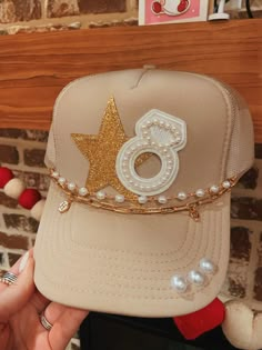 This hat is a must have for brides!! This hat comes with two chains that have clasps on the ends. They are detachable and interchangeable. Please allow up to a week for your item to ship as this is a custom item.  In the personalization box please specify the initial charm that you would like on the chain. Trendy Gold Snapback Hat, Trendy Gold Cap, Trendy Adjustable Gold Hats, Adjustable Gold Hats For Gifts, Adjustable Gold Hats As Gift, Gold Adjustable Trucker Hat Trendy, Trendy Adjustable Gold Trucker Hat, Adjustable Gold Trucker Hat, Gold Adjustable Trucker Hat