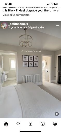 an image of a bedroom with white furniture and pictures on the wall above the bed