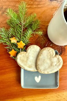 two heart shaped cookies sitting on top of a blue plate