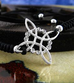 Material: 100% sterling silver, textile Size: Knot is about 3/4 inch wide x 3/4 inch tall (20 X 20 mm) Bracelet is adjustable from 6 to 9 inches (equivalent). See description below Item number: wh385 This witch's knot - a representation of the protective knot used by witches in the Middle Ages to keep away negative energy - is intertwined with a circle, a symbol of perfection, divinity and eternity. Spaced between the arms of the witch's knot are four decorative scrolls that call to mind the lem Unique Silver Adjustable Bracelet, Silver Adjustable Band Bracelet As Gift, Silver Sterling Braided Bracelet With Sliding Knot, Silver Adjustable Band Bracelet For Gift, Sterling Silver Braided Bracelet With Sliding Knot, Adjustable Silver Braided Bracelet With Sterling Clasp, Sterling Silver Jewelry With Sliding Knot In Silver, Adjustable Silver Braided Bracelet, Adjustable Bohemian Sterling Silver Braided Bracelet