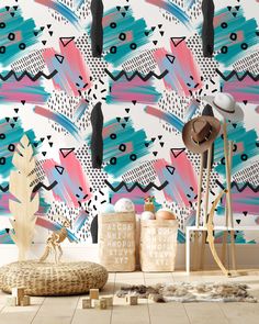 an abstract wallpaper design with pink, blue and black shapes on the wall next to a wooden stool