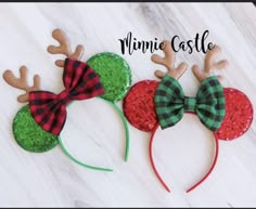 three christmas mouse ears with red, green and black plaid bows on top of them