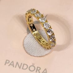 New Pandora Sparkling Row Eternity 14k Golden Plated Size 7 / 54 With Box Fast Shipping Same Day Before 3pm Central Time This Beautiful Ring From Pandora Is Perfect For Any Special Occasion, Whether It's An Engagement, Wedding, Anniversary, Or Birthday. The Ring Is Plated With 14k Golden And Features A Sparkling Row Of Stones In An Eternity Style. The Ring Is A Size 7 Or 54 And Is Made In Thailand.