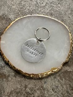 a keychain with a disc that says, i hope there is no place like home