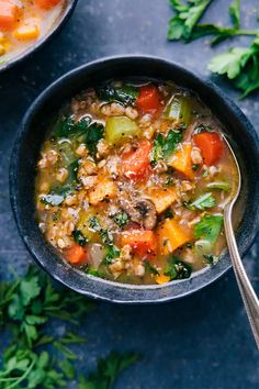 two bowls of vegetable soup on a blue surface