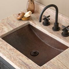 a bathroom sink sitting under a mirror next to a faucet