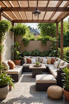 an outdoor living area with couches and potted plants