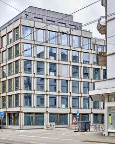 an office building on the corner of a street with no cars parked in front of it