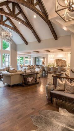 a living room filled with furniture and large windows