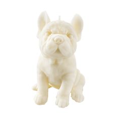 a small white dog figurine sitting on top of a white surface with it's eyes closed