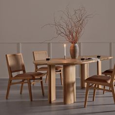 a wooden table with four chairs around it