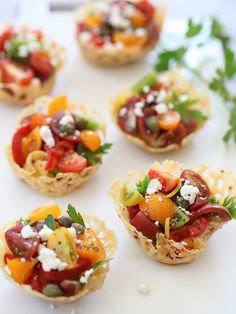 small appetizers are arranged on a white platter