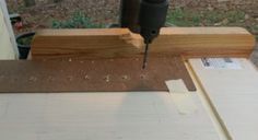 a piece of wood being cut with a drill