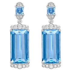 This collection features an array of Aquamarines with an icy blue hue that is as cool as it gets! Accented with Diamonds these Drop Earrings are made in White Gold and present a classic yet elegant look. Aquamarine Drop Earring in 18Karat White Gold with White Diamond. Aquamarine: 14.03 carat, 16.8X9.1X5.9mm size, octagon shape. Aquamarine: 0.57 carat, 4X4mm size, square shape. White Diamond: 0.13 carat, 2.00mm size, round shape, G color, VS clarity. White Diamond: 0.11 carat, 1.50mm size, round Blue Diamond Cut Earrings Fine Jewelry, Luxury Blue Teardrop Diamond Earrings, Luxury White Gold Tanzanite Earrings, Luxury Brilliant Cut Blue Topaz Earrings, Classic Blue Diamond-cut Earrings, Butterfly Pin, Blue Tanzanite, Naha, Icy Blue