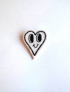 I hand embroidered this cute and kitschy heart brooch on a light cream organic muslin with black thread and then hand sewed it to a soft, thick, sturdy piece of cream felt. I love brooches to jazz up any outfit, and this cute one would look so sweet on a denim jacket!The brooch is 2 1/4 inches across at it's widest point and almost 3 inches long. The silver plated pin back is 1 1/2 inches across.Please let me know if you have any questions or would be interested in purchases this brooch in multi Cute Handmade Pins As Gifts, Cute Handmade Pins For Gifts, Cute White Pins For Gifts, Cute White Brooch For Gift, Cute White Brooches For Gift, Cute White Brooches For Gifts, Kitsch Jewelry, Christmas Tree Star Topper, Felt Hair Clips