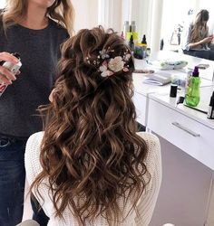 a woman is getting her hair done in the salon