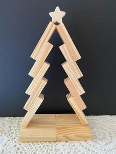 a wooden christmas tree with a star on top