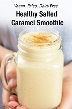 a person holding a glass jar filled with healthy salted caramel smoothie recipe