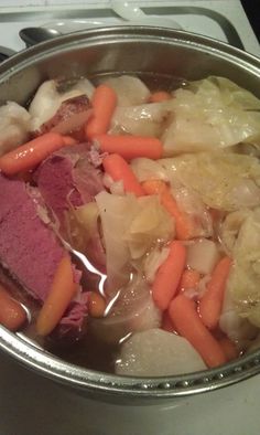 a pot filled with meat and vegetables on top of a stove