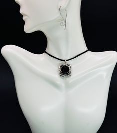 Please read Before purchasing, please review all information provided by seller. Keep in mind the items displayed on the mannequin, which is different the human neck, all measurements you can see in description and at the picture #2. The Choker ~Handmade ~Unique design ~Gift wrap ~Material: Sterling silver, natural Obsidian ~Charm width: 7 mm / 0.28 inch ~Charm height: 7 mm / 0.28 inch ~Charm color: silver Product description: Men's Pendant Necklace - Bold and Masculine Statement Jewelry. Elevate your style with our men's pendant necklace, a bold and distinctive accessory crafted for the modern man. This statement piece combines rugged masculinity with refined design, creating a versatile necklace that effortlessly complements any wardrobe. This pendant is versatile enough to complement ca Black Amulet Necklace With Large Pendant, Black Spiritual Pendant Jewelry, Adjustable Silver Obsidian Necklace, Spiritual Black Pendant Jewelry, Spiritual Black Jewelry With Large Pendant, Onyx Large Pendant Jewelry As Gift, Onyx Jewelry With Large Pendant As Gift, Obsidian Amulet Necklace As Gift, Obsidian Amulet Necklace For Gift