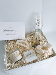 the bridesmaid gift box includes personalized items such as wine glasses, bracelets and napkins