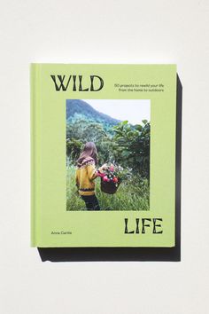 a book with the title wild life written in black on it and a photo of a child holding flowers