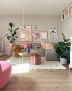 a living room filled with furniture and lots of plants