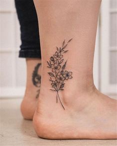 a small flower tattoo on the ankle