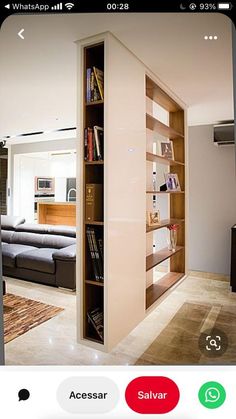 an iphone photo of a living room with bookshelves and couches in it