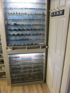 there is a large display case with many toy boats in the front and behind it