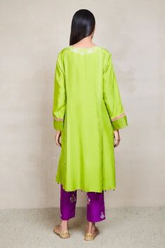 Yellow green kurta highlighted with floral resham-applique embroidery, V-neckline, full sleeves and straight silhouette. Comes with purple pant and organza dupatta.
Component: 3
Embroidered
Neckline: V-Neck
Sleeve Length: Full
Fabric: Silk, Organza
Color: Green, Purple
Zari, resham and applique embroidery
Straight kurta
Embroidered pant
Scallop edged dupatta with tassels - Aza Fashions V Neck Kurta, Kurta Set For Women, Purple Pants, Embroidered Pants, Straight Kurta, Organza Dupatta, Applique Embroidery, Embroidered Neckline, Silk Organza