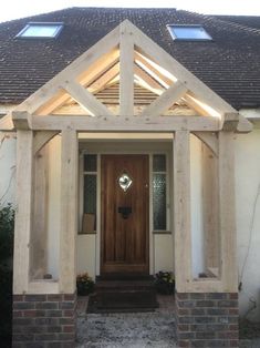 a house with a wooden front door and two windows